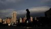 A pedestrian is silhouetted against a backdrop of buildings in a park in Hong Kong. Comprehending the scale and importance of what is going on in Asia, both economically and politically, and its already palpable impact on our region and on the structure of world economic and political power is no easy task. (Photo: AAP)