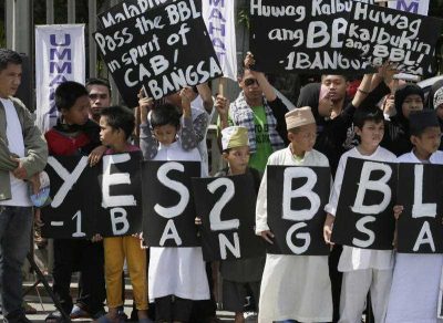 Filipino Muslims display placards during a rally at the Philippine Senate to coincide with the hearing at the Upper House on the passage of the Bangsamoro Basic Law (BBL) which would establish an autonomous region in the southern Philippines, 25 May 2015, Manila, Philippines.
