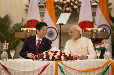 Indian Prime Minister Narendra Modi talks with his Japanese counterpart Shinzo Abe at a ceremony, in New Delhi, India. (Photo: AAP)