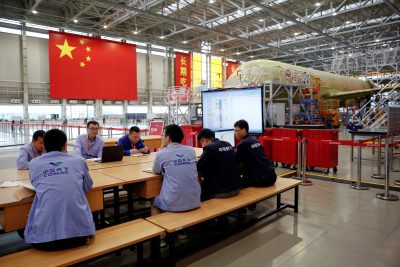Employees work on a China's homegrown C919 passenger jet at Manufacturing and Final Assembly Center of state-owned Commercial Aircraft Corporation of China (COMAC) during a media tour in Shanghai, China 4 May 2017. (Photo: Reuters/Aly Song).