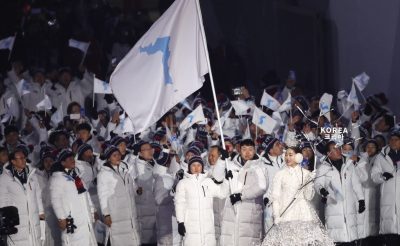 North Korean ice hockey player Hwang Chung-gum and South Korean bobsledder Won Yun-jong carry the unification flag during the opening ceremony (Photo: Reuters/Kim Kyung-Hoon).