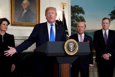US President Donald Trump, flanked by Lockheed Martin CEO Marillyn Hewson, Commerce Secretary Wilbur Ross and US Trade Representative Robert Lighthizer, delivers remarks before signing a memorandum on intellectual property tariffs on high-tech goods from China, at the White House in Washington, US on 22 March 2018. (Photo: Reuters/Jonathan Ernst)