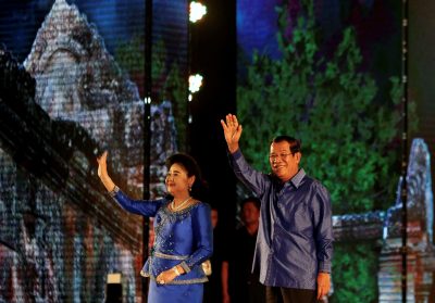 Cambodia's Prime Minister Hun Sen and his wife Bun Rany greet people during a commemorating the 10th anniversary of Preah Vihear temple and the first anniversary of Sambo Prei Kuk temple’s being listed as a UNESCO World Heritage Site, Phnom Penh, Cambodia, 15 July 2018 (Photo: Reuters/Samrang Pring).