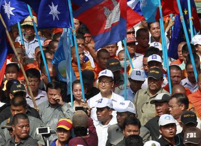 Sam Rainsy, President of the opposition Cambodia National Rescue Party (CNRP), walks with his supporters during a protest in Phnom Penh, Cambodia, 25 October 2013. The CNRP rejects the official results of the fifth national assembly elections, which declared Prime Minister Hun Sen's ruling Cambodian People's Party as winner. (Photo; AAP)
