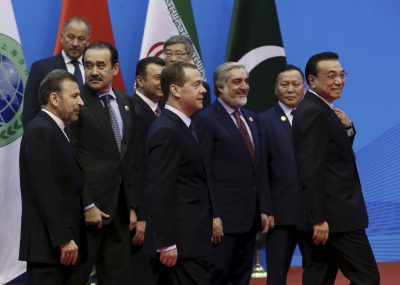 Chinese Premier Li Keqiang (right), Russian Prime Minister Dmitry Medvedev (centre) and other foreign leaders leave after taking group pictures during the 14th Shanghai Cooperation Organisation (SCO) Prime Ministers' Meeting, in Zhengzhou, China, 15 December 2015. (Photo: Reuters/Ekaterina Shtukina).