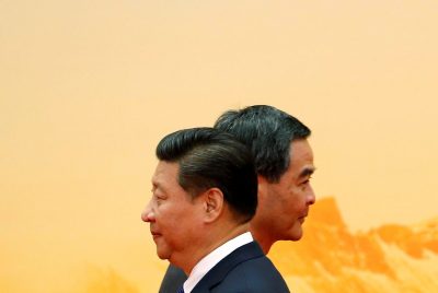 Hong Kong Chief Executive Leung Chun-ying walks past China's President Xi Jinping during a welcoming ceremony of Asia Pacific Economic Cooperation (APEC) forum in Beijing, 11 November 2014 (Photo: Reuters/Kim Kyung-Hoon)