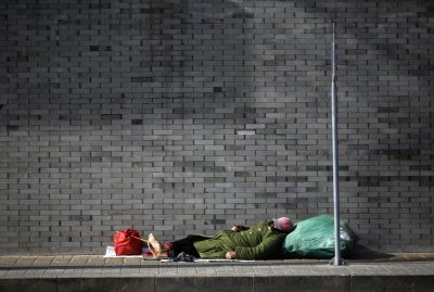 A man takes a nap on a street in Beijing, China, 6 February 2015. (Photo: Reuters/Kim Kyung-Hoon). 