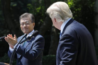 South Korean President Moon Jae-in (L) applauds next to US President Donald Trump while delivering a joint statement from the Rose Garden of the White House in Washington, US, 30 June 2017. (Photo: Reuters/Carlos Barria).