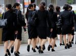 Female office workers wearing high heels, clothes and bags of the same colour make their way at a business district in Tokyo, Japan, 4 June 2019 (Photo: Reuters/Kim Kyung-Hoon).
