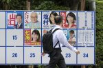 A man walks past a poster board erected in Tokyo with candidates' posters for the July 21 Upper House election (Photo: Rodrigo Reyes Marin/AFLO/Reuters).
