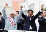 Japanese Prime Minister and leader of the ruling Liberal Democratic Party (LDP) Shinzo Abe raises his hands with his party candidate Keizo Takemi (L) at a campaign for the July 21 Upper House election in Tokyo on Sunday 7, July, 2019. (REUTERS/Yoshio Tsunoda)