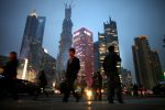 People walk along a busy street at Pudong financial district in Shanghai, March, 2013 (Photo: Reuters/ Barria).