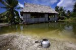 An abandoned house that is affected by seawater during high-tides stands next to a small lagoon near the village of Tangintebu, South Tarawa, Kiribati, 25 May 2013 (Photo: Reuters/David Gray).