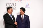 China's President Xi Jinping is greeted by Japan's Prime Minister Shinzo Abe at the G20 leaders summit in Osaka, Japan, 28 June 2019 (Photo: Reuters/Kevin Lamarque).