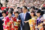 Japanese Prime Minister Shinzo Abe, accompanied by his wife Akie, poses for photos at a cherry blossom party he hosted in Tokyo, Japan, 13 April 2019 (Photo: Reuters/Tomoko Hagimoto).