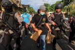 Anti-terrorism policemen carry an envelope after a raid at the house of suspect Nur Rohman at Sukoharjo district near Solo, Indonesia, 19 July 2016 (Reuters/Antara Foto/Maulana Surya/via third party).