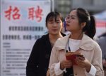 A Chinese job seeker looks for employment at a job fair at the Fuyang Normal University in Fuyang city, east China's Anhui province, 16 March 2019 (Photo: Reuters).