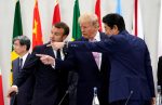 Japan's Prime Minister Shinzo Abe, U.S. President Donald Trump and France's President Emmanuel Macron gesture together during a meeting at the G20 leaders summit in Osaka, Japan, 28 June 2019 (Photo: Reuters/Lamarque).
