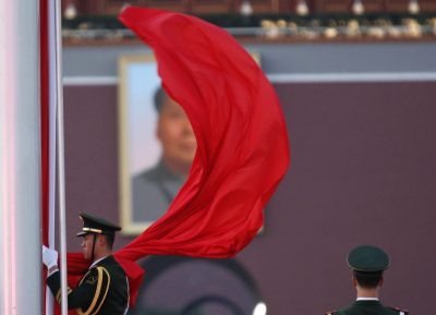 A paramilitary policeman holds the Chinese national flag at a flag lowering ceremony on Tiananmen square next to the Great Hall of the People (Photo: REUTERS/Kim Kyung-Hoon).