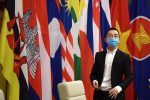 An official wearing a face mask looks on as Vietnam's Prime Minister Nguyen Xuan Phuc attends a special video conference with leaders of the Association of Southeast Asian Nations (ASEAN) on the coronavirus disease (COVID-19), in Hanoi 14 April 2020 (Photo: Reuters/Manan Vatsyayana).