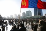 A protester waves a Mongolian flag during a demonstration at Sukhbaatar Square in Ulaanbaatar, Mongolia, 27 December 2018 (Photo: Reuters/B. Rentsendorj).