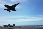 An F18 fighter takes off from the deck of the USS Theodore Roosevelt while transiting the South China Sea, 10 April 2018 (Photo: Reuters/Karen Lema).