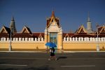 A woman walks outside the Royal Palace which has being closed for visitors as precaution against the coronavirus outbreak in Phnom Penh, Cambodia, 19 March 2020 (Photo: Reuters/Cindy Liu).