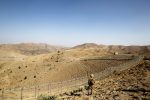 A Pakistani soldier stands guard along a border fence outside the Kitton outpost on the border with Afghanistan in North Waziristan, Pakistan, 18 October 2017 (Photo: Reuters/Caren Firouz).