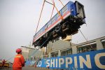 Workers help load a carriage of a China Railway High-speed train that is to be exported to Sri Lanka onto a COSCO container ship at a port in Qingdao, Shandong province, China, 3 March 2020 (Photo: China Daily/ Reuters).