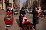 Women walk with children in a street following the outbreak of the coronavirus disease (COVID-19) in Wuhan, Hubei province, China, 15 January, 2021 (Reuters/Thomas Peter).