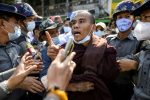 Police detain a Buddhist monk while he takes part in a protest in support of the jailed nationalist right wing monk Wirathu outside Insein prison in Yangon, Myanmar, 16 January 2021 (Photo: Reuters/Shwe Paw Mya Tin).