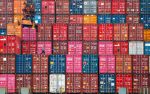 A worker walks on stacks of containers at the Tanjung Priok port in Jakarta, Indonesia, 22 January 2021 (Photo: Reuters/Ajeng Dinar Ulfiana).