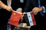 Chinese and Syrian businessmen set up their national flags during a meeting to discuss reconstruction projects in Syria, Beijing, China, 8 May 2017 (Photo: Reuters/Jason Lee).