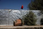A part of a minaret broken off from the former Xinqu Mosque lies near a Chinese national flag in a yard adjacent to the former house of worship in Changji outside Urumqi, Xinjiang Uyghur Autonomous Region, China, 6 May 2021 (Photo: Reuters/Thomas Peter).