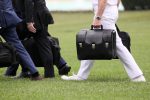 A military aide carries the so-called nuclear football as he walks to board the Marine One helicopter in Washington, DC, 8 May 2019 (Photo: Reuters/Jonathan Ernst).