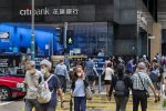 Pedestrians cross the street at a traffic light in front of the American multinational investment bank, Citibank or Citi, branch in Hong Kong, (Photo: Reuters/Budrul Chukrut/ SOPA Images/Sipa USA).