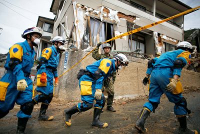 Rescue workers and Japan Self-Defense Force soldiers search for missing people at a landslide site caused by a heavy rain in Kumano Town, Hiroshima Prefecture, western Japan, 11 July 2018 (Photo: Reuters/Issei Kato).