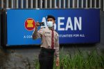 A police officer takes a picture outside the Association of Southeast Asian Nations (ASEAN) secretariat building, ahead of the ASEAN leaders' meeting in Jakarta, Indonesia, 23 April 2021 (Photo: Reuters/Willy Kurniawan).