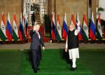 India's Prime Minister Narendra Modi and Russia's President Vladimir Putin wave ahead of their meeting at Hyderabad House in New Delhi, India, 6 December 2021. (Photo: Reuters/Adnan Abidi).