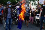 Protesters against Myanmar's junta burn the flag of the Association of Southeast Asian Nations (ASEAN), in Mandalay, Myanmar, 5 June 2021 (Photo: Reuters/Stringer).