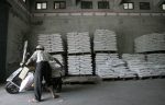 A man packs sacks of fertiliser at a rice factory in Ilan County, Taiwan (Photo: Reuters/Pichi Chuang)