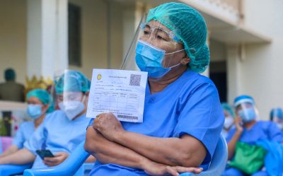 A medical worker holds her identity document while waiting for a shot with the dose of covishield COVID-19 vaccine at Mandalay's city hall. Myanmar begins its COVID-19 vaccination drive as neighbouring India has donated 1.5 million doses of vaccines. Photo by Kaung Zaw Hein / SOPA Images/Sipa USA