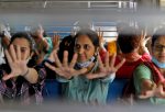 Women perform yoga in a local train on the occasion of International Women's Day in Mumbai, India, 8 March 2022 (Photo: Reuters/Niharika Kulkarni).