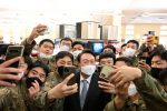 South Korea's president-elect takes selfies with South Korean soldiers during his visit to US Army Garrison Humphreys in Pyeongtaek, South Korea, 7 April 2022. (U.S. Forces Korea/Yonhap via Reuters Connect)