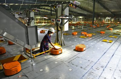 A worker uses Automated Guided Vehicles at Flipkart, a leading e-commerce firm in India, to sort items inside its fulfilment centre in Bengaluru, India, 23 September 2021 (Photo: Reuters/Samuel Rajkumar).