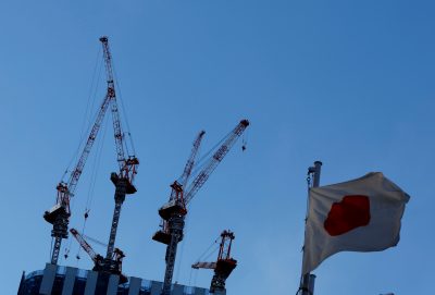 Japan's national flag flutters in front of a construction site of a commercial building in Tokyo (Photo: Reuters/Kim Kyung-Hoon)