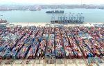 An aerial view shows containers and cargo vessels at the Qingdao port in Shandong province, China, 9 May 2022 (Photo: Reuters/China Daily).
