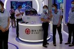 Staff members stand near a counter promoting China's digital yuan, or e-CNY, at the 2021 China International Fair for Trade in Services, Beijing, China, 3 September 2021 (Photo: Reuters/Florence Lo).