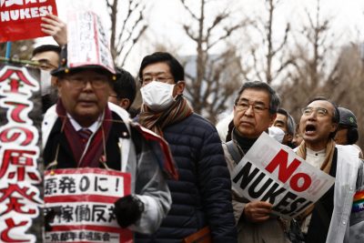 Protesters hold signs during a rally against nuclear power in central Tokyo on March 8, 2015 (Photo: Reuters/Thomas Peter).