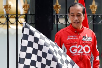 Indonesian President Joko Widodo looks at the racing flag as he opens the parade of MotoGP racers outside the Merdeka Presidential Palace, ahead of the Indonesian Grand Prix on Lombok island, in Jakarta, Indonesia, 16 March 2022 (Photo: Reuters/Willy Kurniawan).